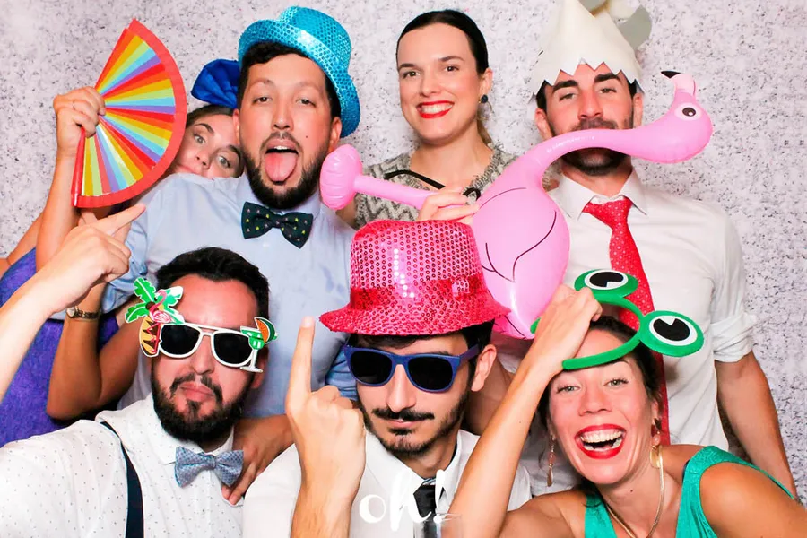 Young people posing in a photo booth with funny costumes