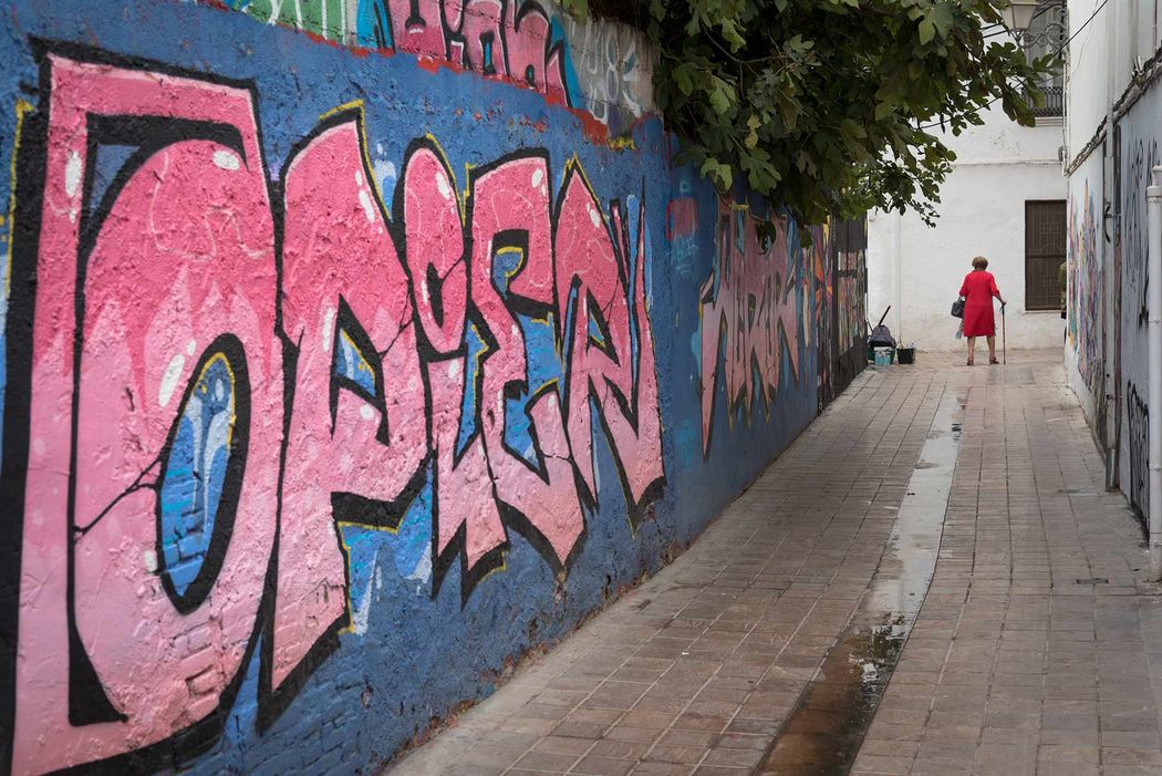 old lady in red in graffiti festival in valencia spain