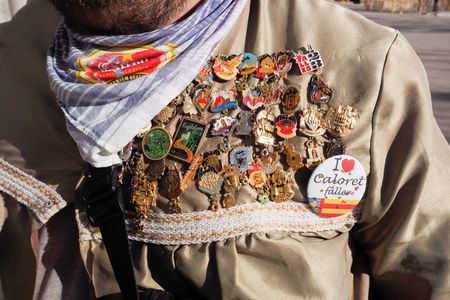 several condecorations in a fallero dress in valencia fallas