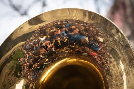 reflection of people in a musical instrument