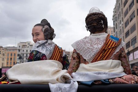 two valencian falleras in a car from behing