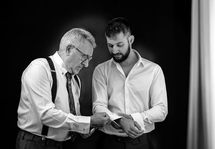 Blanco y negro padre novio ayudándole a colocarse los gemelos. Boda Cóctel Esturión de Coria, Sevilla. Fotógrafo de bodas en Andalucía (España)