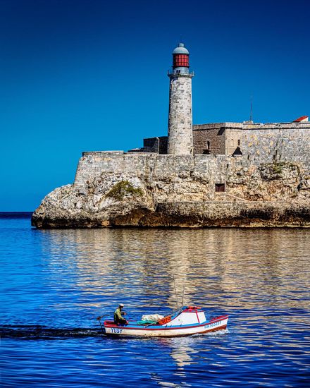 Small boat entering the bay of Havana with El Morro in the background