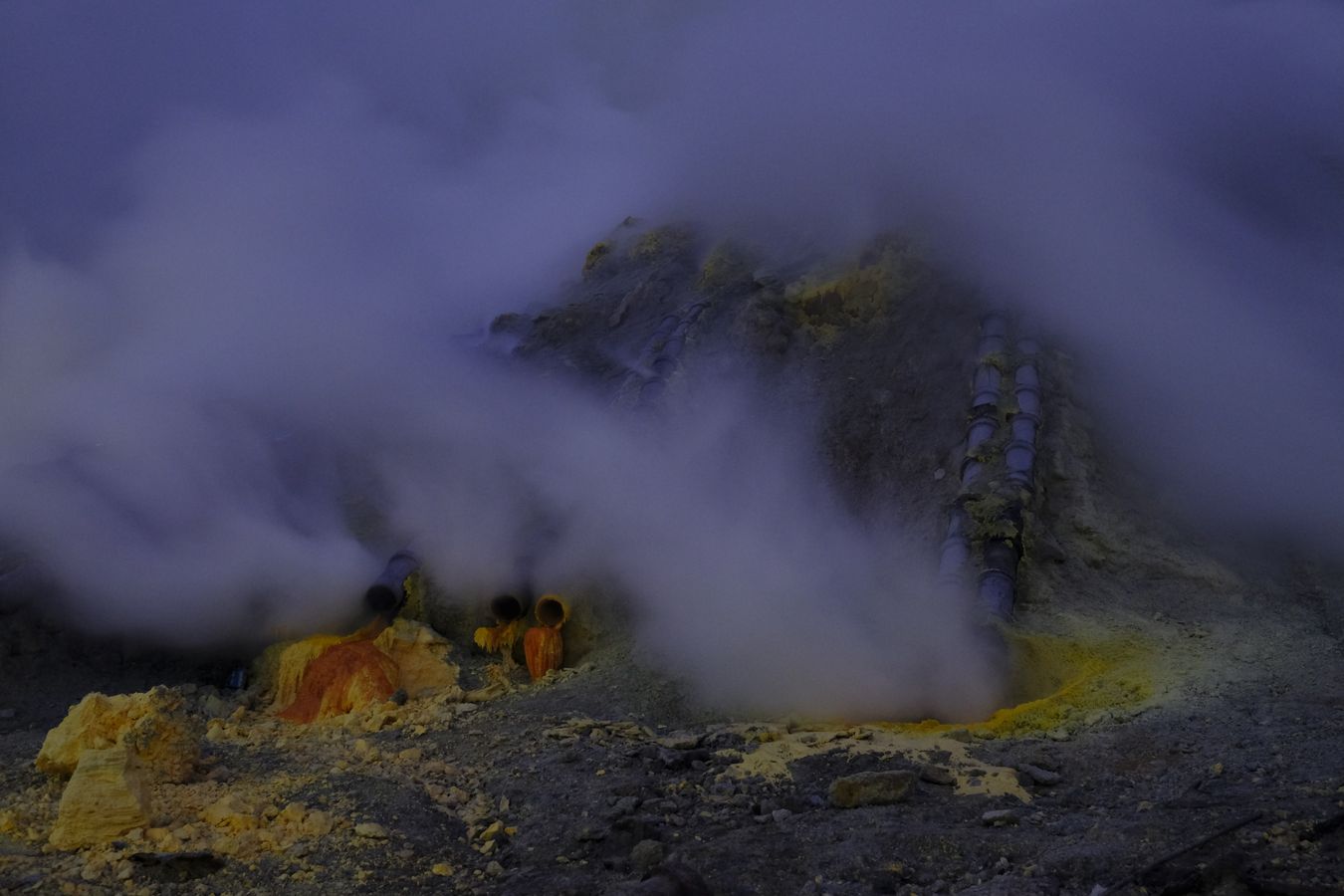 Smoke rising from the chimneys in the caldera of Ijen volcano