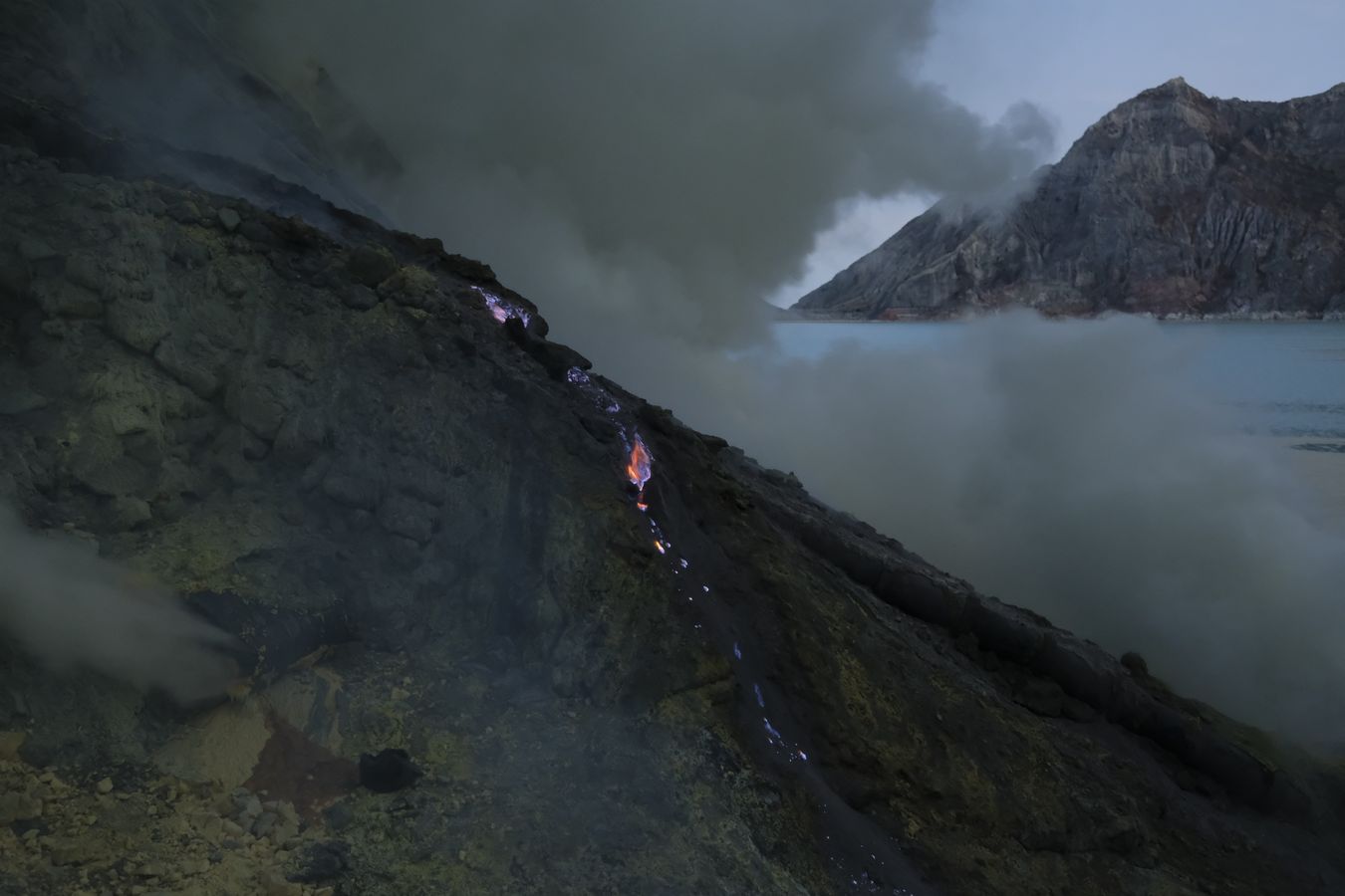 Dawn breaks over the caldera of the Ijen volcano