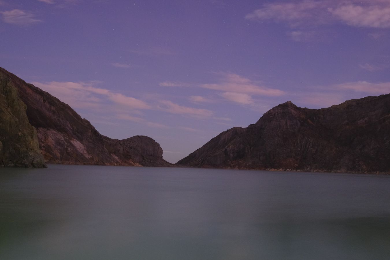 Sunrise on the lake in the crater of the Ijen volcano