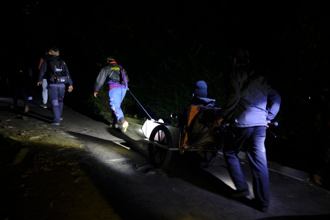 Wheelbarrow porters carry tourist up to the summit of Ijen volcano