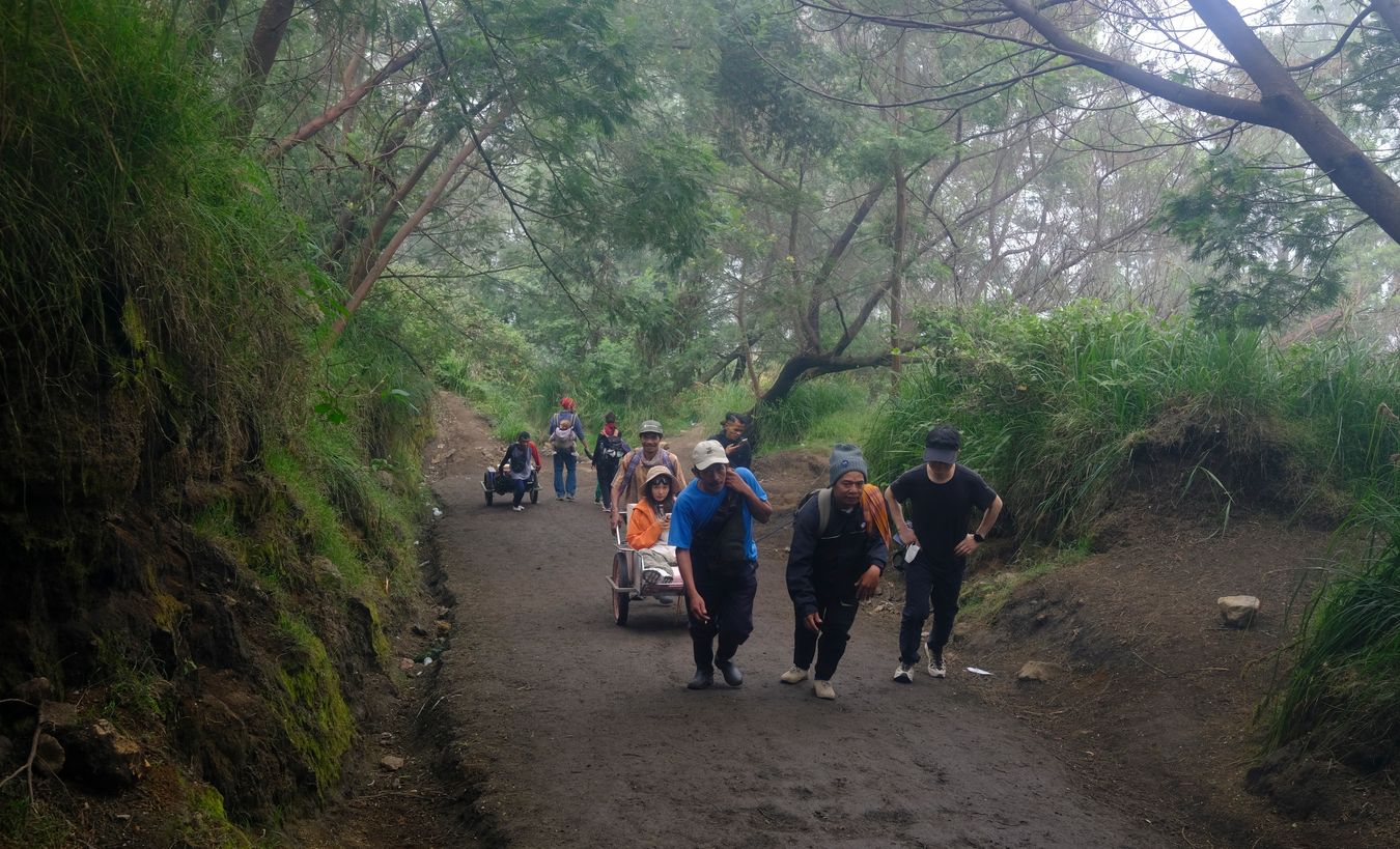 Whellbarrow porters carry tourists up to the summit of Ijen volcano