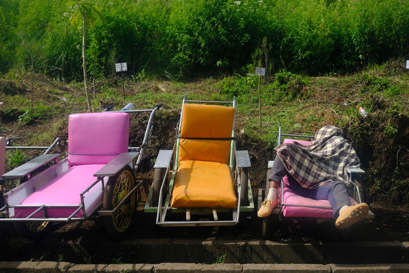 A porter rests on his wheelbarrow at the start of the climb to Ijen volcano