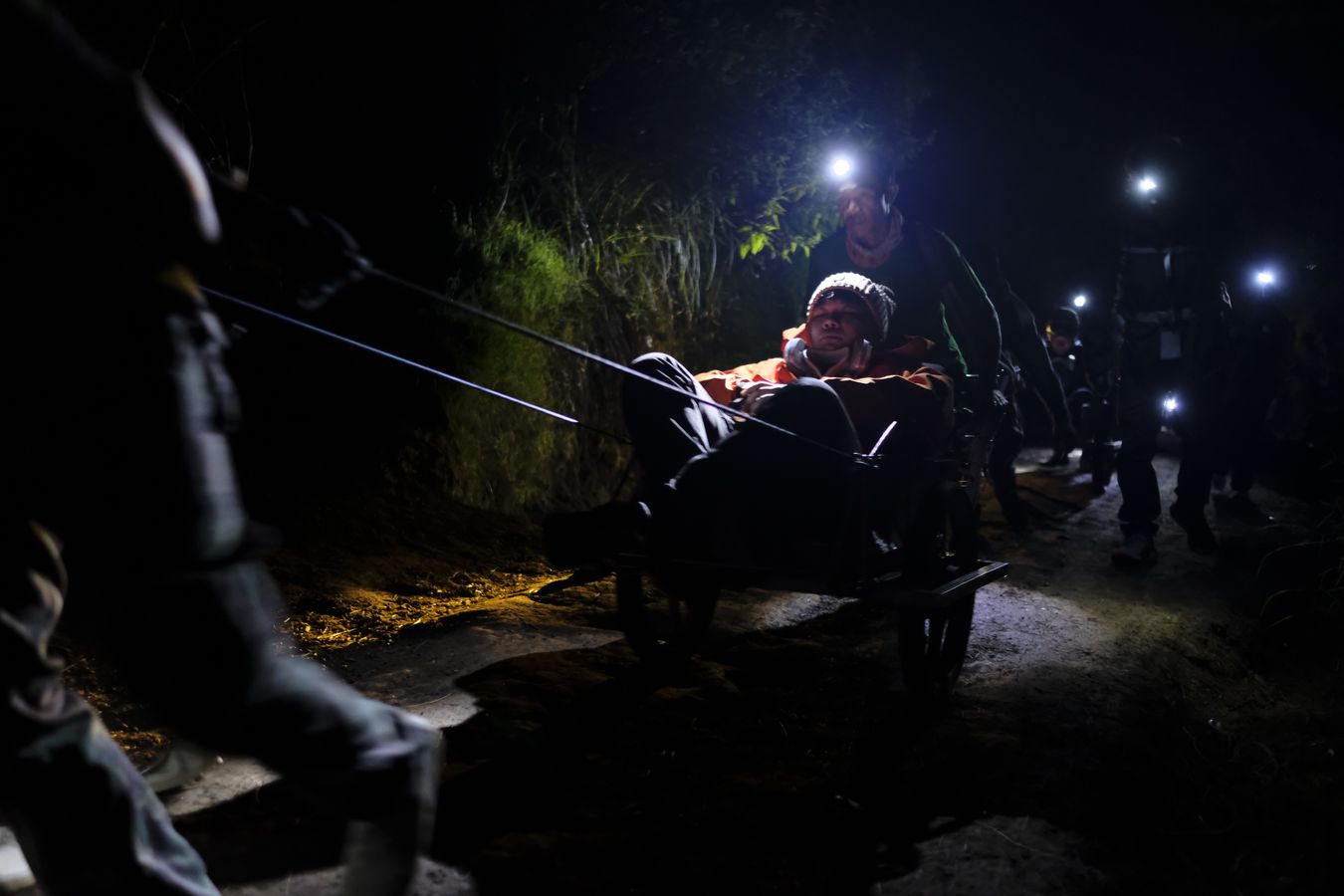 Wheelbarrow porters carry tourists up to the summit of Ijen volcano