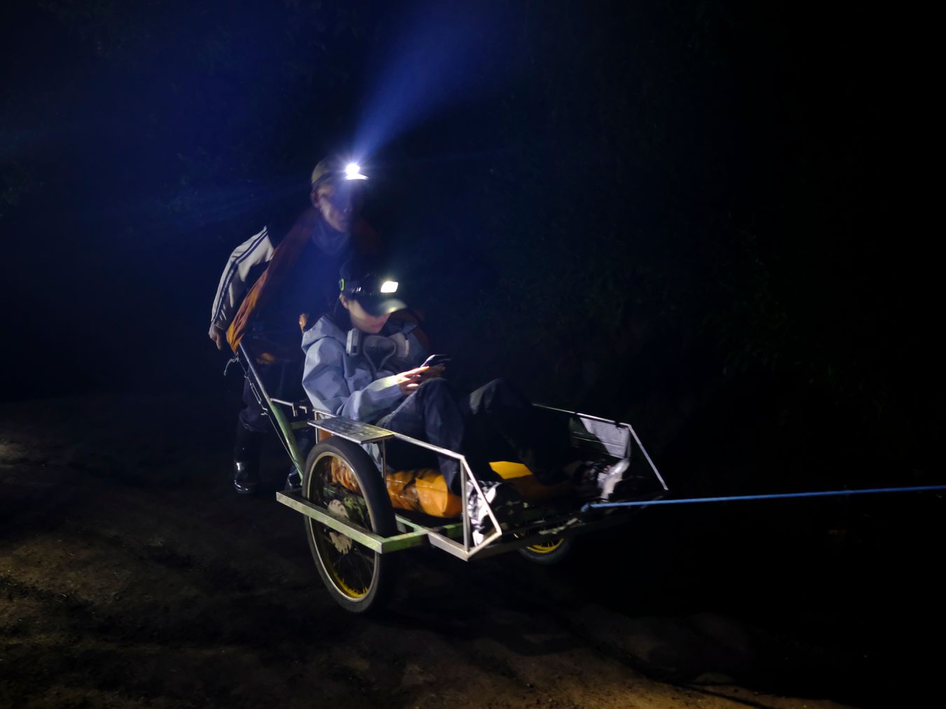 Wheelbarrow porter carry tourist up to the summit of Ijen volcano