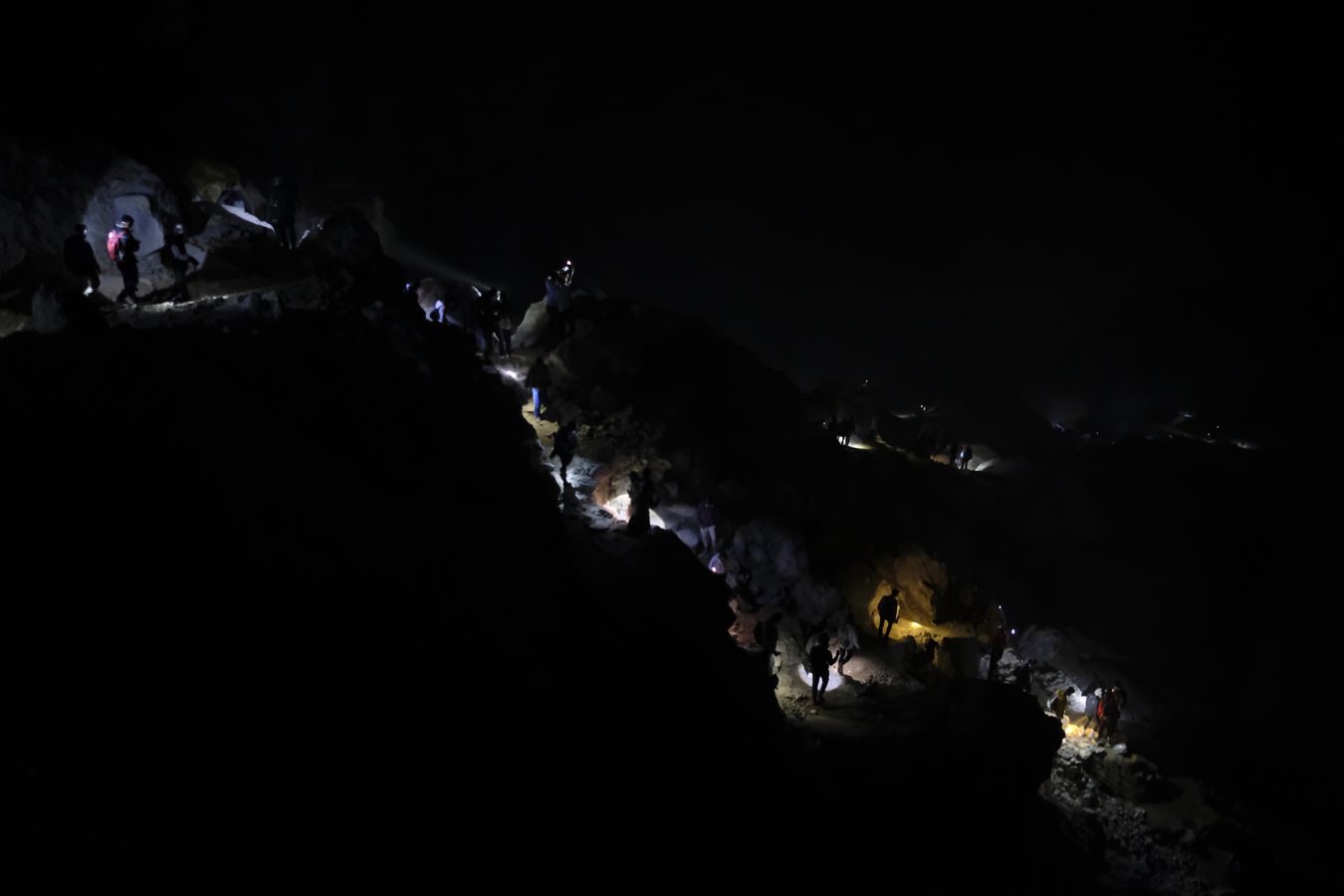 Visitors descend into the crater of Ijen volcano