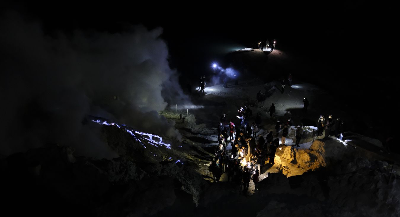 Visitors watch the blue lava in the crater of the Ijen volcano