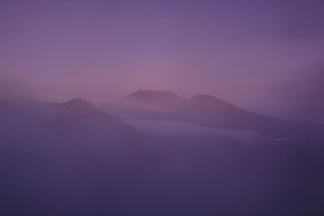 Smoke anf fog shroud other volcanic cones around Ijen volcano