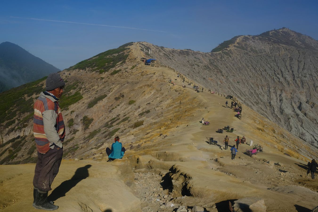 The last miners and porters in the morning before descending from Ijen volcano