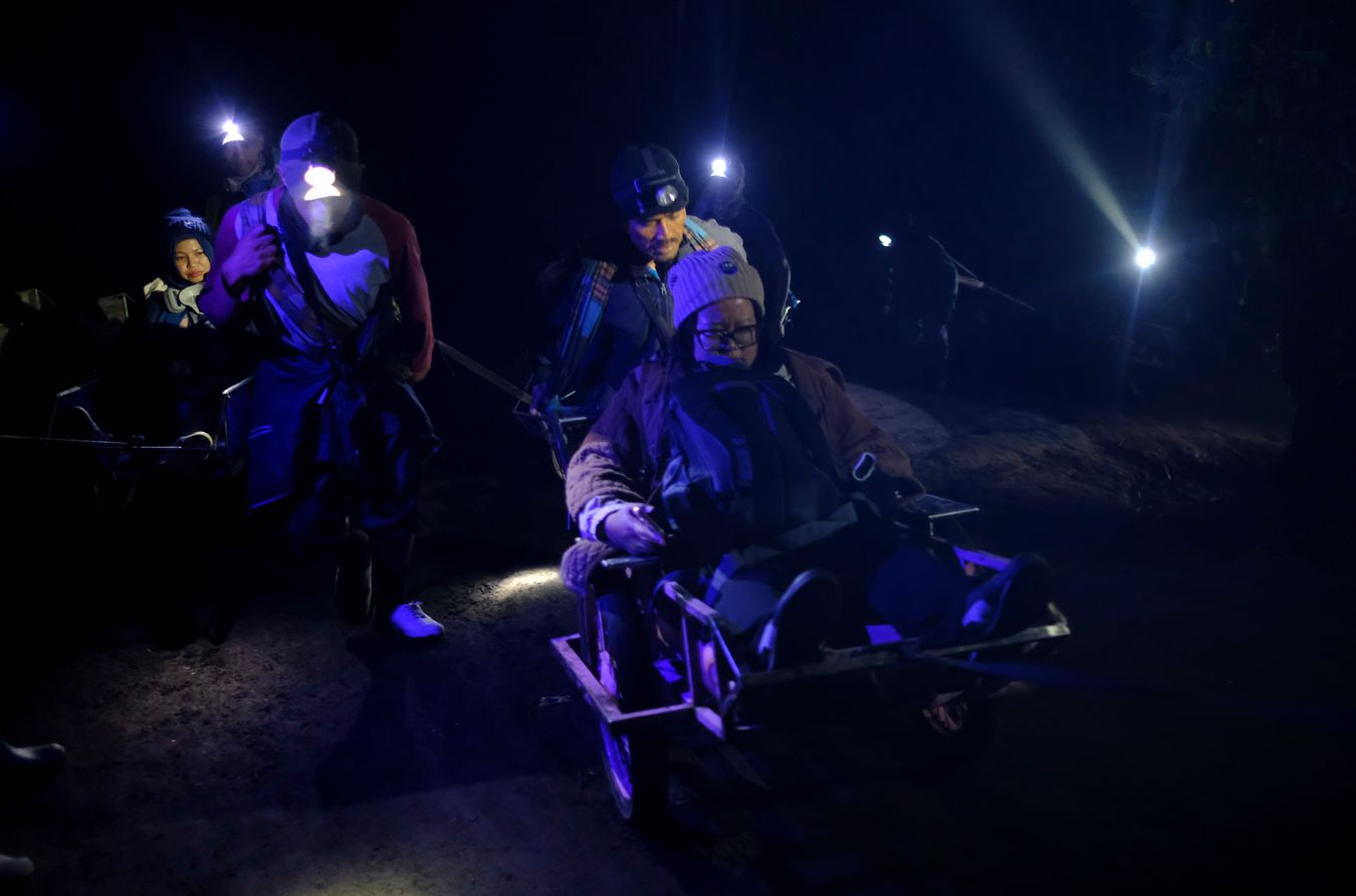 Wheelbbarrow porters carry tourists up to the summit of Ijen volcano