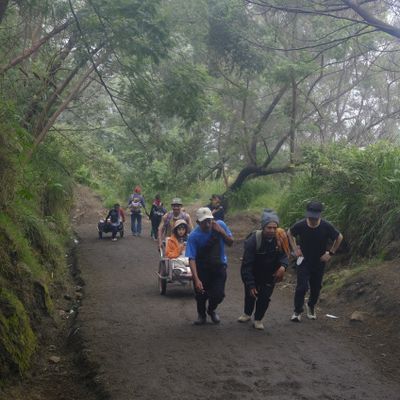 Whellbarrow porters carry tourists up to the summit of Ijen volcano