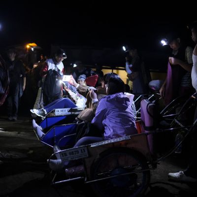 Wheelbarrow porters and tourists take a break on the way up to the top of Ijen volcano