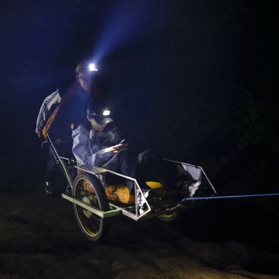 Wheelbarrow porter carry tourist up to the summit of Ijen volcano