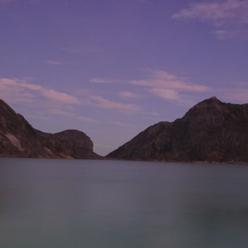 Sunrise on the lake in the crater of the Ijen volcano