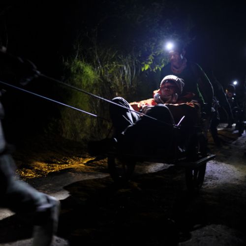 Wheelbarrow porters carry tourists up to the summit of Ijen volcano