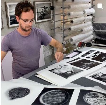 Alfredo Sarabia selecting fine art prints in his printer studio in havana