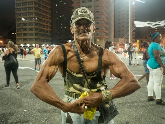 muscle man posing for a picture in havana´s carnival, cuban photography