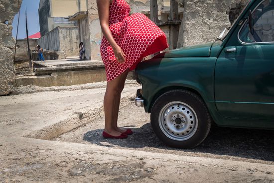 legs of a cuban woman with a little car