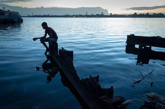 cuban man fishing in cuba sea by louis alarcon