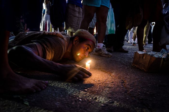 candles and pilgrims in a travel of photography in honour of saint lazarus in cuba