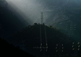 High voltage Towers in the landscape, at backlight. Distribution of electric energy