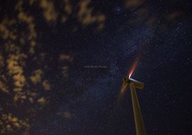 Wind turbines at starry night